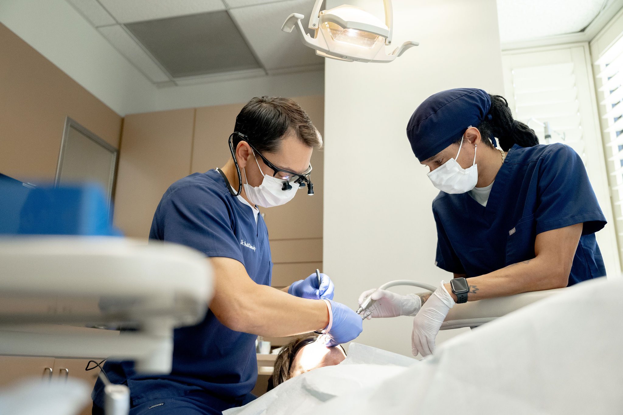 Two clinicians during a surgical procedure