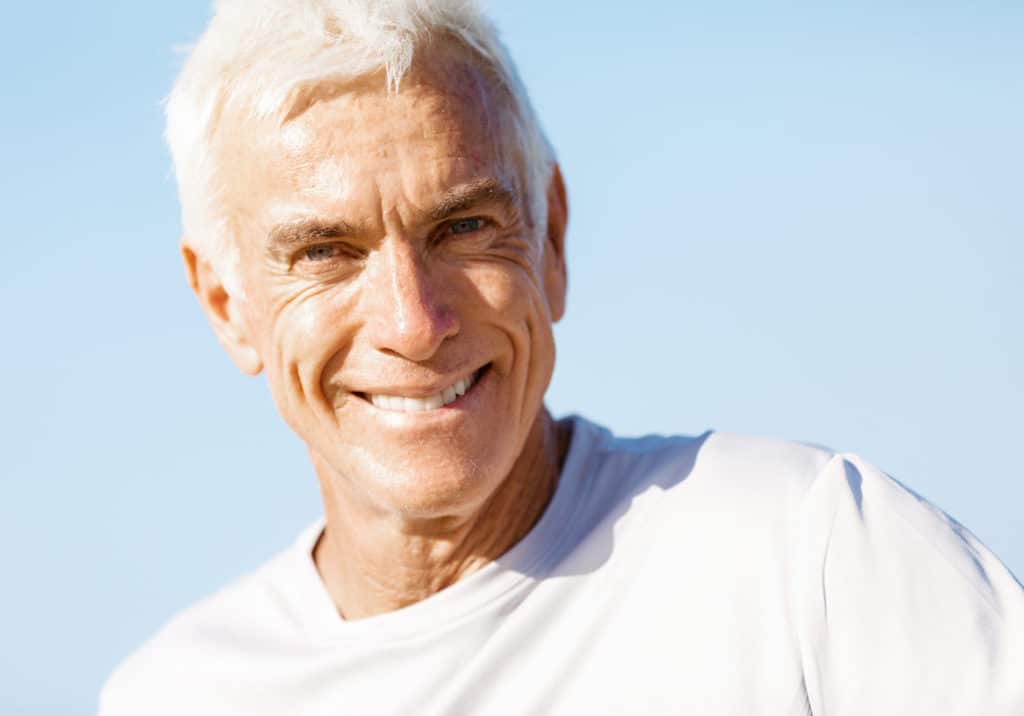 Portrait of healthy senior man smiling at camera
